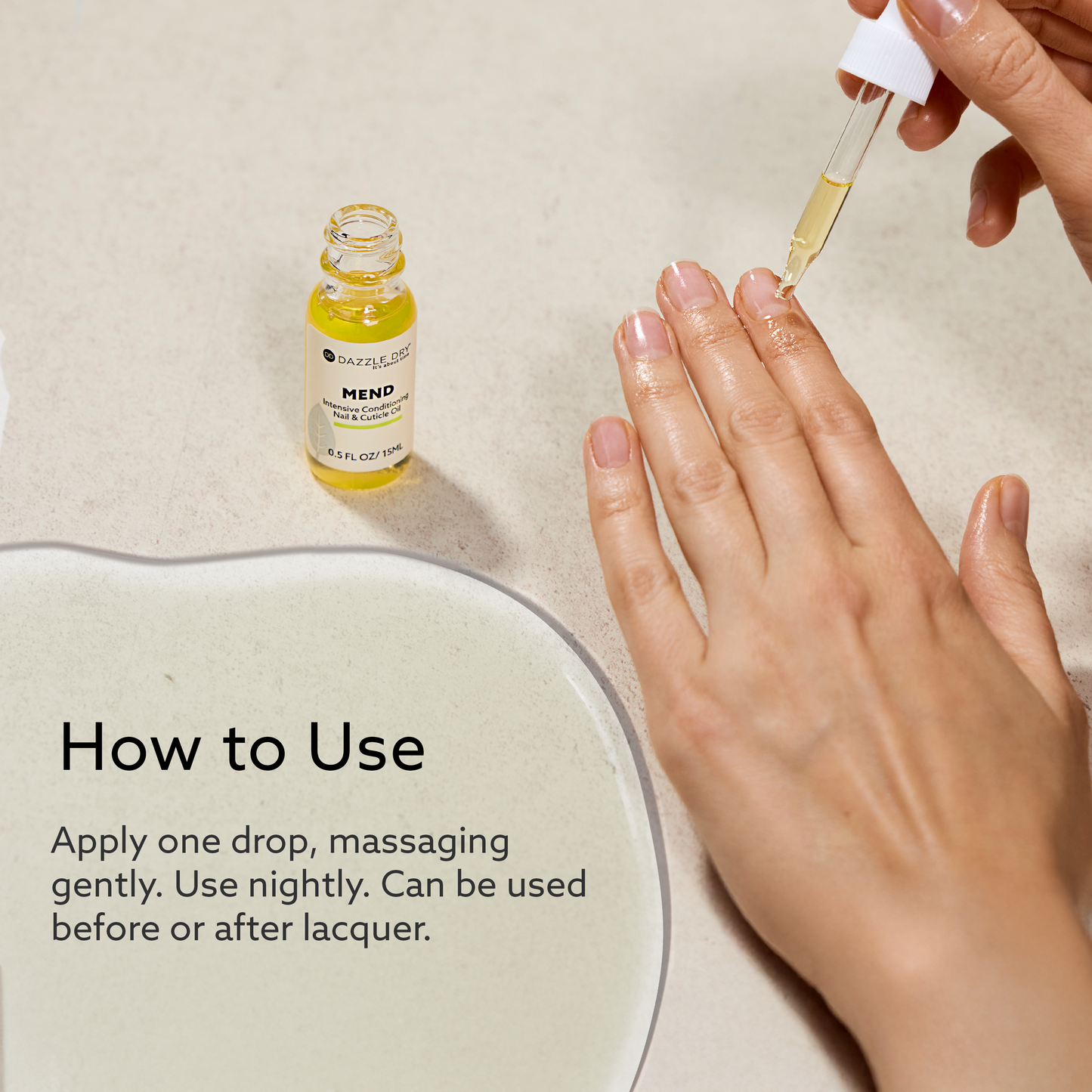 Hand applying Dazzle Dry MEND Intensive Conditioning Nail & Cuticle Oil to nails using a dropper, with usage instructions displayed on a neutral background