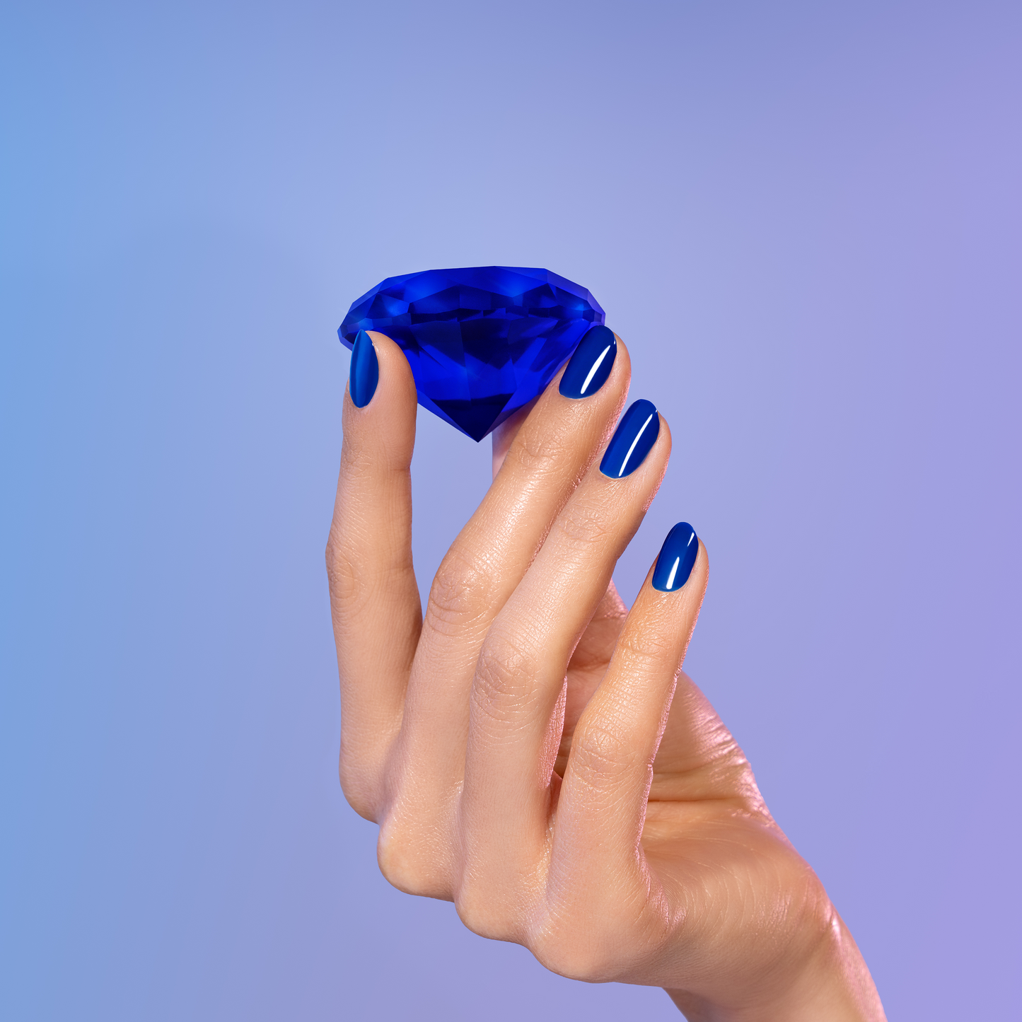 Hand holding a blue gemstone against a gradient purple background
