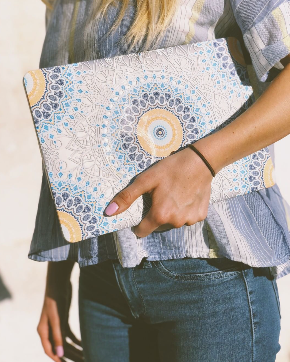 Hand with Soft Caress painted on nails holding a laptop