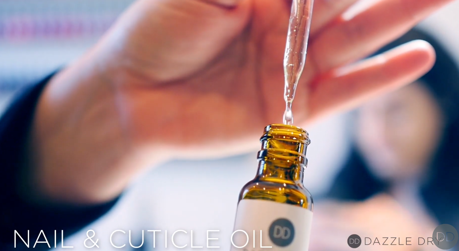 Thumbnail of Silva demonstrating how to use nail cuticle oils Mend and Maintain by Dazzle Dry, with play button overlay.