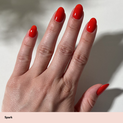 Hand with red nail polish on a neutral background