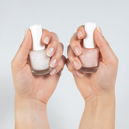 Hands with Transform + Bare Transform painted on nails holding Transform and Bare Transform bottles