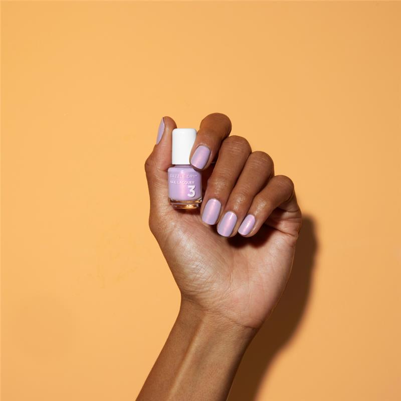 Hand with Lovely Lilac painted on nails holding mini lacquer bottle