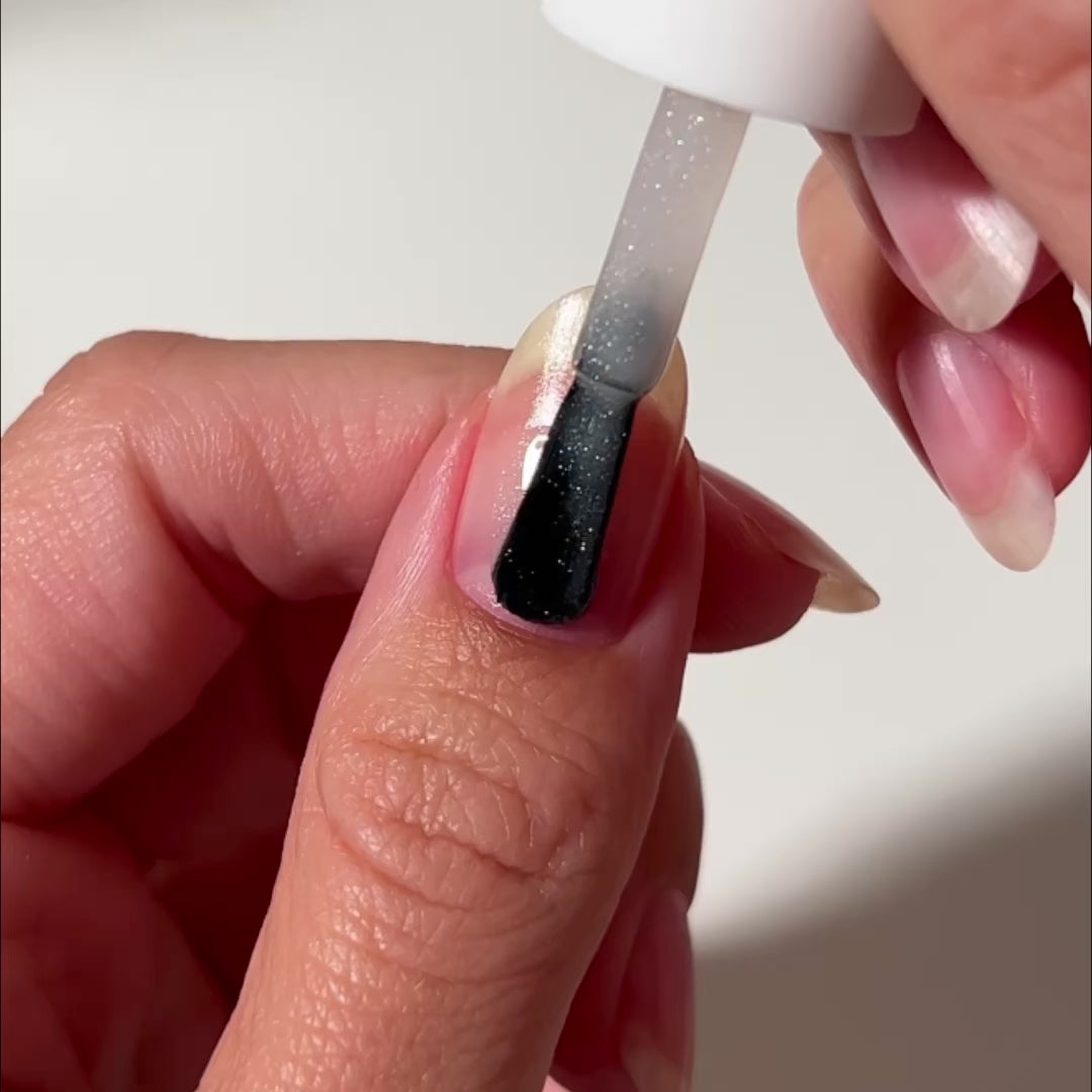 Video of Cushion Cut nail Polish painted on nail. A white and silver shimmery sheer polish.