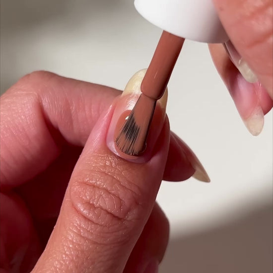 video of brown nail polish painted onto nail