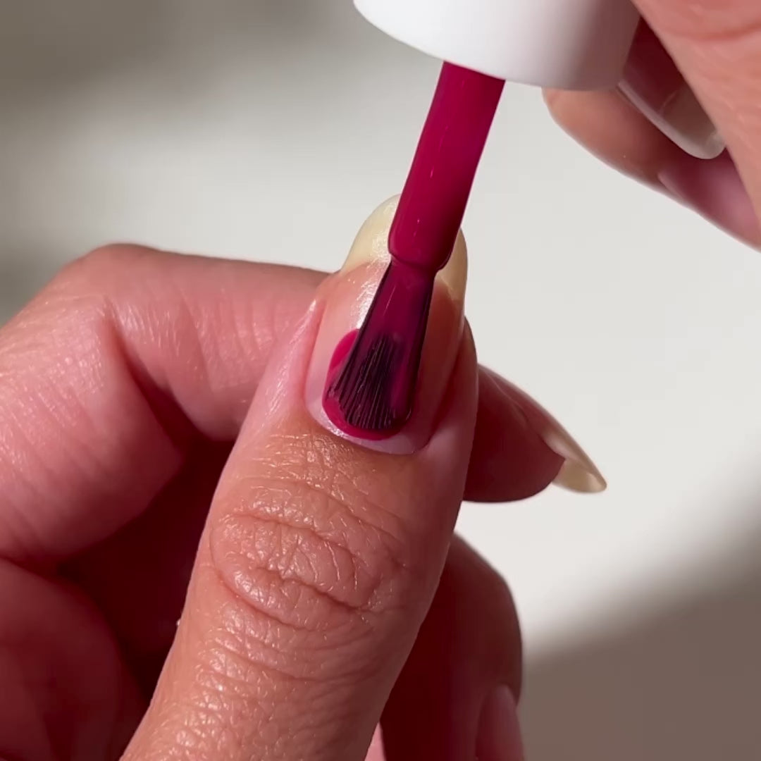 video of pink nail polish painted onto nail 
