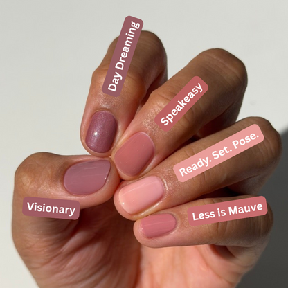 A close-up of a hand displaying six different nail polish shades with descriptive labels overlaid on each nail. The shades range from dusty mauve and pink to soft peach and nude, with labels reading 'Day Dreaming', 'Speezy', 'Visionary', 'Ready, Set.