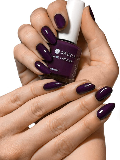 Hands with Stolen Kiss painted on nails holding lacquer bottle