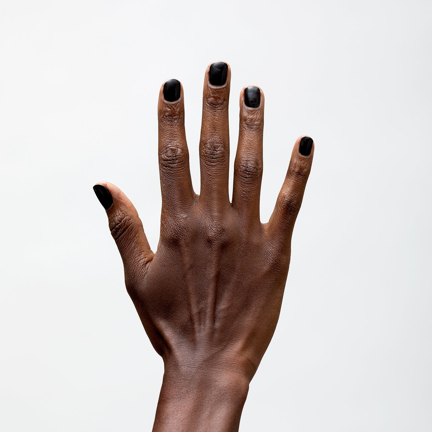 Hand with Bold painted on nails