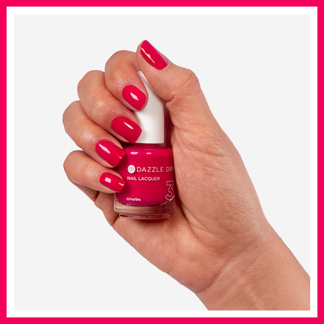 Hand with Fantasy painted on nails holding lacquer bottle