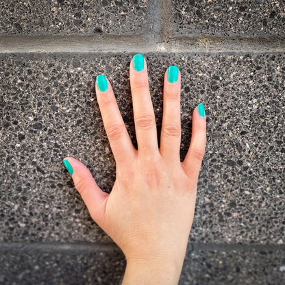Hand with Palm Springs painted on nails